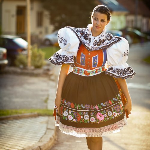 keeping tradition alive , young woman in a richly decorated ceremonial folk dress