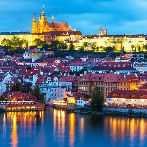 scenic summer evening panorama of the old town architecture with vltava river and st.vitus cathedral in prague