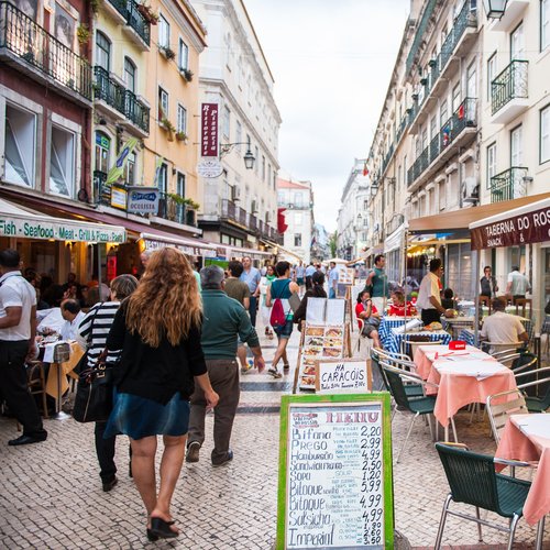 tourists walk and eat in the touristic area in lisbon