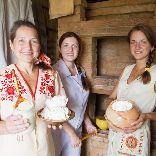 women with farm-style meal in rural house