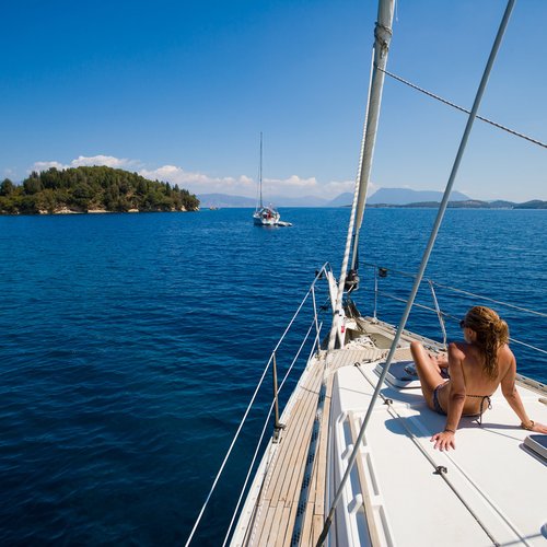 young woman sailing on yacht in greece